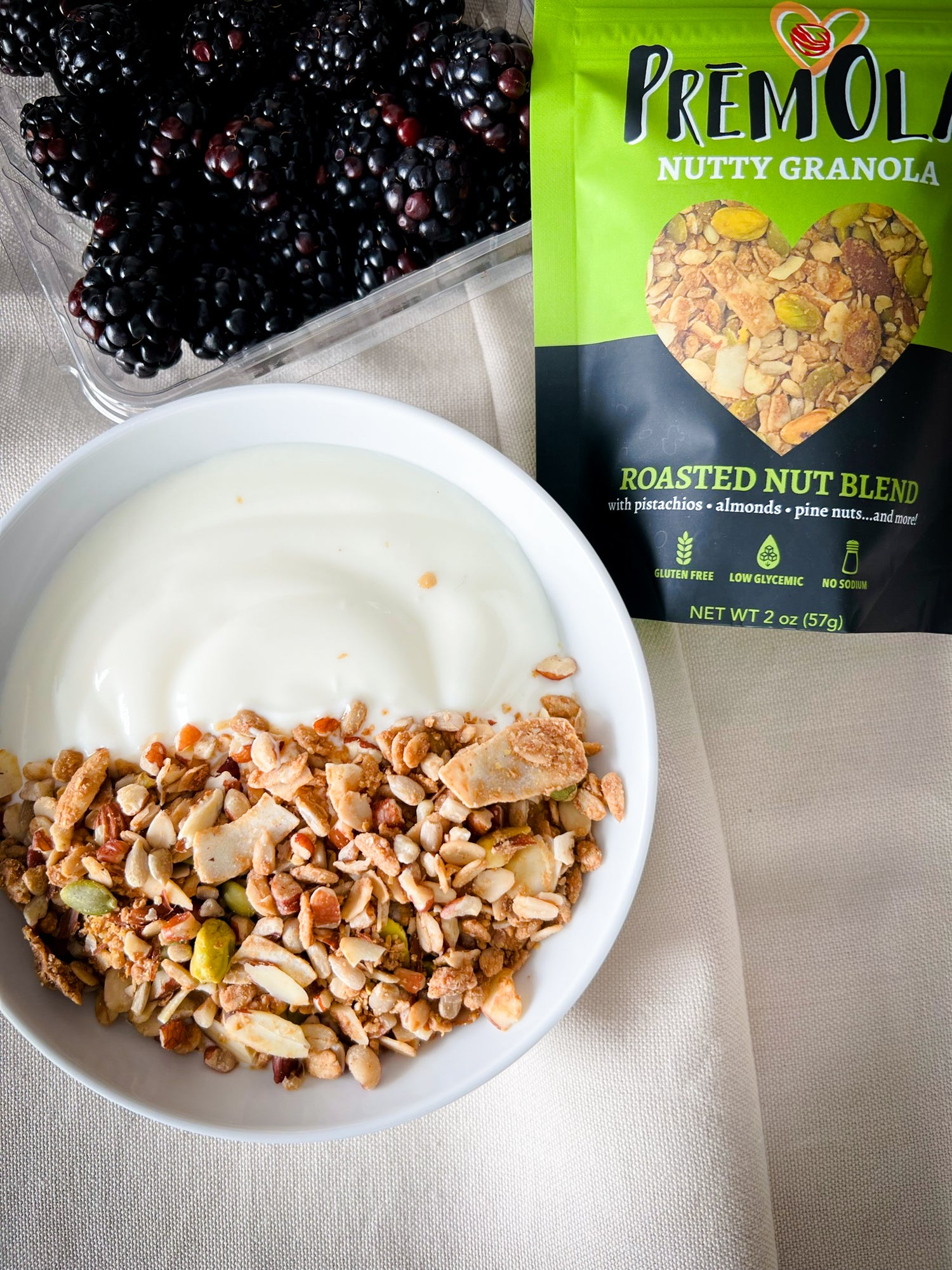 PremOla Roasted Nut Granola product image; premium granola bag featuring nut-based blend with almonds, pistachios, sunflower seeds, and organic pine nuts.